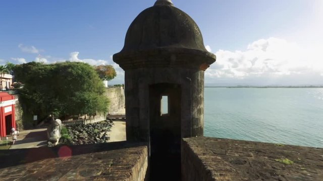 Cool shot moving towards inside of garita in Old San Juan and then see ocean