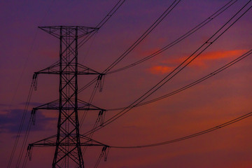 Electricity station. Close up high voltage power lines at sunset.