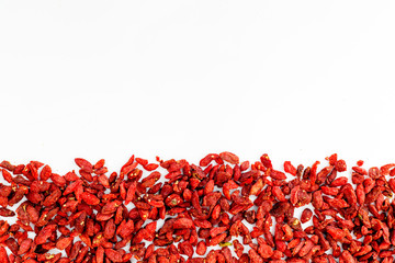 Dried goji berries on white background top view copyspace pattern