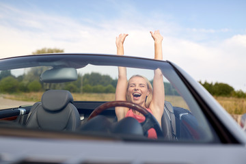 happy young woman in convertible car