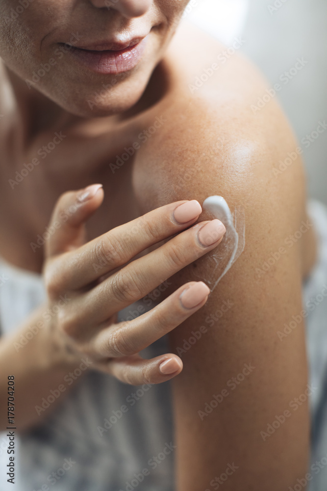 Wall mural Woman Applying Creme on Body