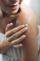 Woman Applying Creme on Body