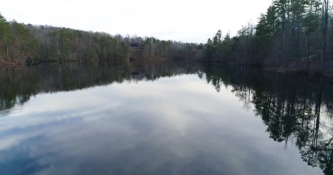 Aerial drone footage over a lake in the mountains