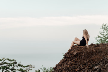 Sexy, beautiful girl seat on rock near the sea, Minnesota, space for text