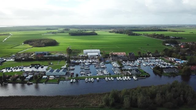 Aerial of harbor with pleasure boats in old city Sloten in the Netherlands- 4K