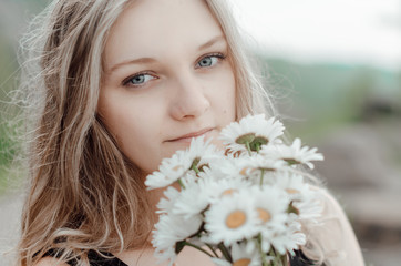 beautiful young girl with a bouquet of flowers