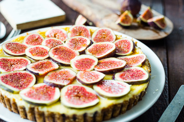 Homemade Delicious Cheesecake with Fresh Figs and Goat Cheese on Brown Rustic Wooden Table