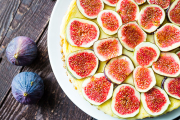 Homemade Delicious Tart with Fresh Figs and Goat Cheese on Dark Rustic Wooden Table, Top View