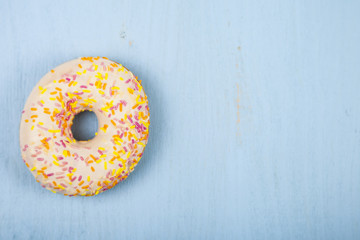 One donut  on a wooden background.