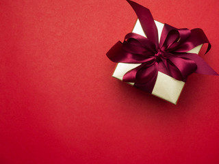 Valentine festival , New year Gold gift box with red ribbon. Red background for create idea copy space.