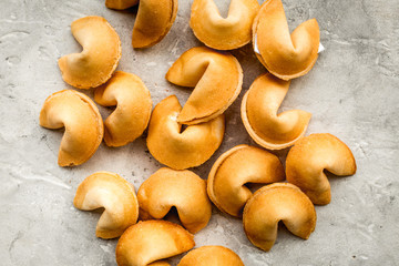 Future prognostic with fortune cookie on stone background top view