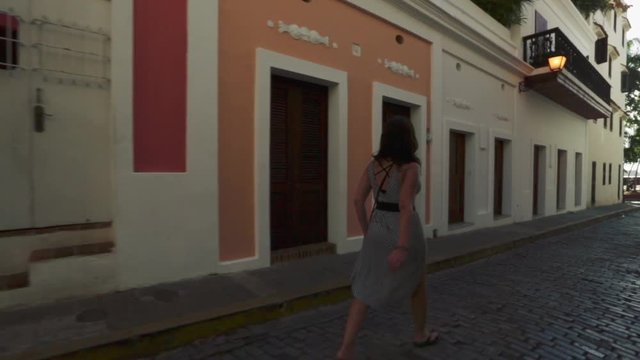 Female tourist walking on cobblestone streets while on vacation