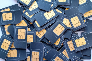 many SIM cards is in a pile - obrazy, fototapety, plakaty