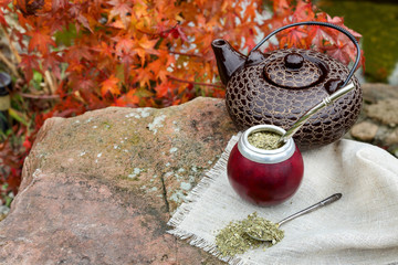 Mate tea in a calabash on a stone table in the garden
