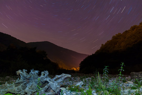 Long exposure photo of night landscape of ravine, mountains and star trails, Sochi, Russia
