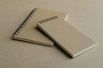 two brown spiral notebooks