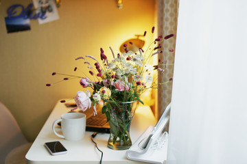 Work at home. Flowers on the table.