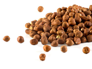 Raw hazelnut on heap isolated on white background