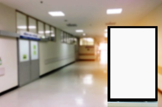 mock up of vertical advertising billboard or blank showcase light box for your text message or media content with blurred image of hospital corridors, commercial, marketing and advertisement concept