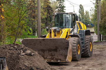 wheel loader clears the road during construction work
