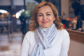 Portrait of smiling mature woman posing at camera