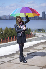 beautiful girl under colorful umbrella on the street