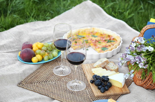 Delicious food for picnic and glasses of wine outdoors