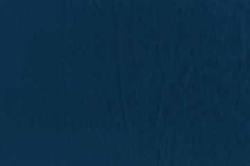 The texture of the wrinkled cloth a dark blue color.