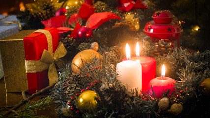 Fototapeta na wymiar Three burning candles on advent wreath at living room
