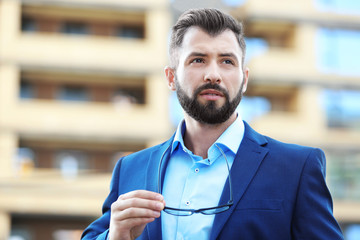 Handsome confident businessman outdoors