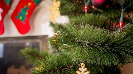 Fototapeta na wymiar Closeup image of beautiful golden bauble hanging on Christmas tree