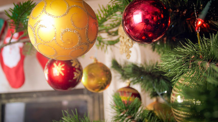 Toned image of Christmas bauble against fireplace at living room