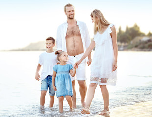 Happy family on sea beach at resort