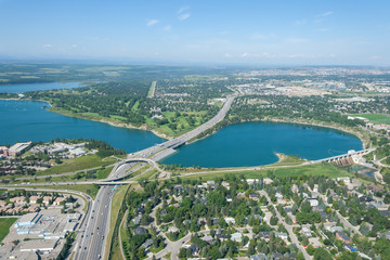 Aerial view of a city and highway running through man made reservoir. Calgary, Alberta, Glenmour Reservoir. 