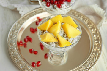Glass dessert bowl with delicious chia seed pudding on metal tray