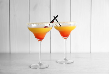 Glasses with tasty exotic cocktail on table