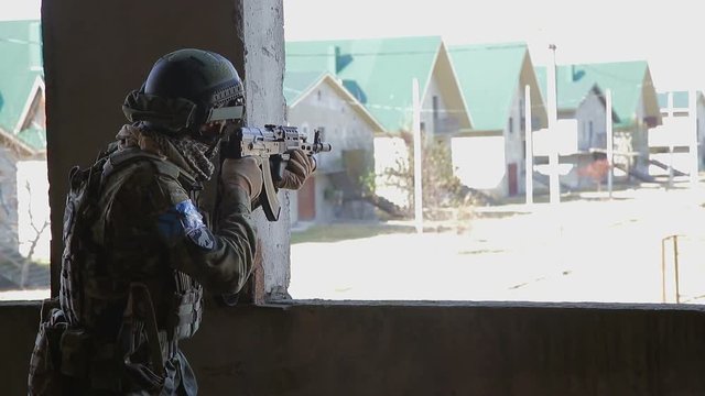 Soldier is aiming at the target during the mission
