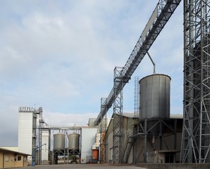 Cereal silos, drying towers and pipes in an industrial agricultural plant © luca piccini basile