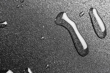 Drops of oil in a teflon frying pan close up.