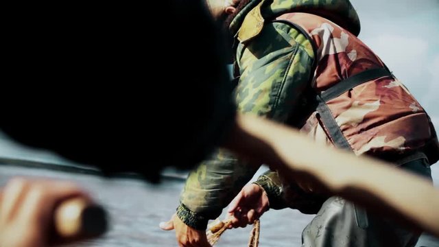The fisherman in a small boat pulls out of the water Fishing net, CU