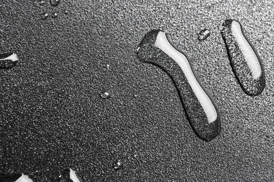 Drops of oil in a teflon frying pan close up.