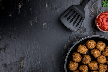 Meatballs on a vintage looking slate slab (selective focus)