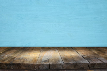 Empty table in front of blue wooden background. For product display montage