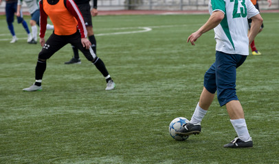 Fototapeta premium Young Soccer Players Running After the Ball.