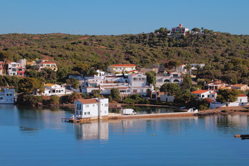 Fototapeta na wymiar Houses on coast of sea gulf. Mahon, Minorca, Spain