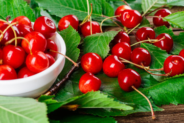 Fresh cherries in bowl on table