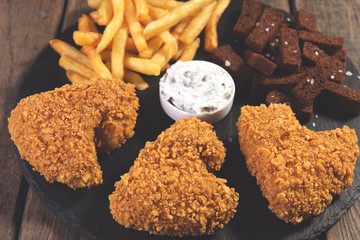 fried chicken wings breaded crispy with french fries fried rye bread croutons beer snack