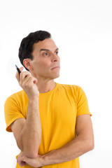 Fototapeta premium Man holds a pen and thinks. He's on his feet. Isolated on white background..