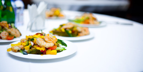 grilled salad with shrimps. plates with salad. delicious. bright salad. restaurant food. a delicacy.