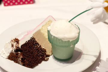 Plate with chocolate cake and ice cream pot with a flower. Focus on the cake.